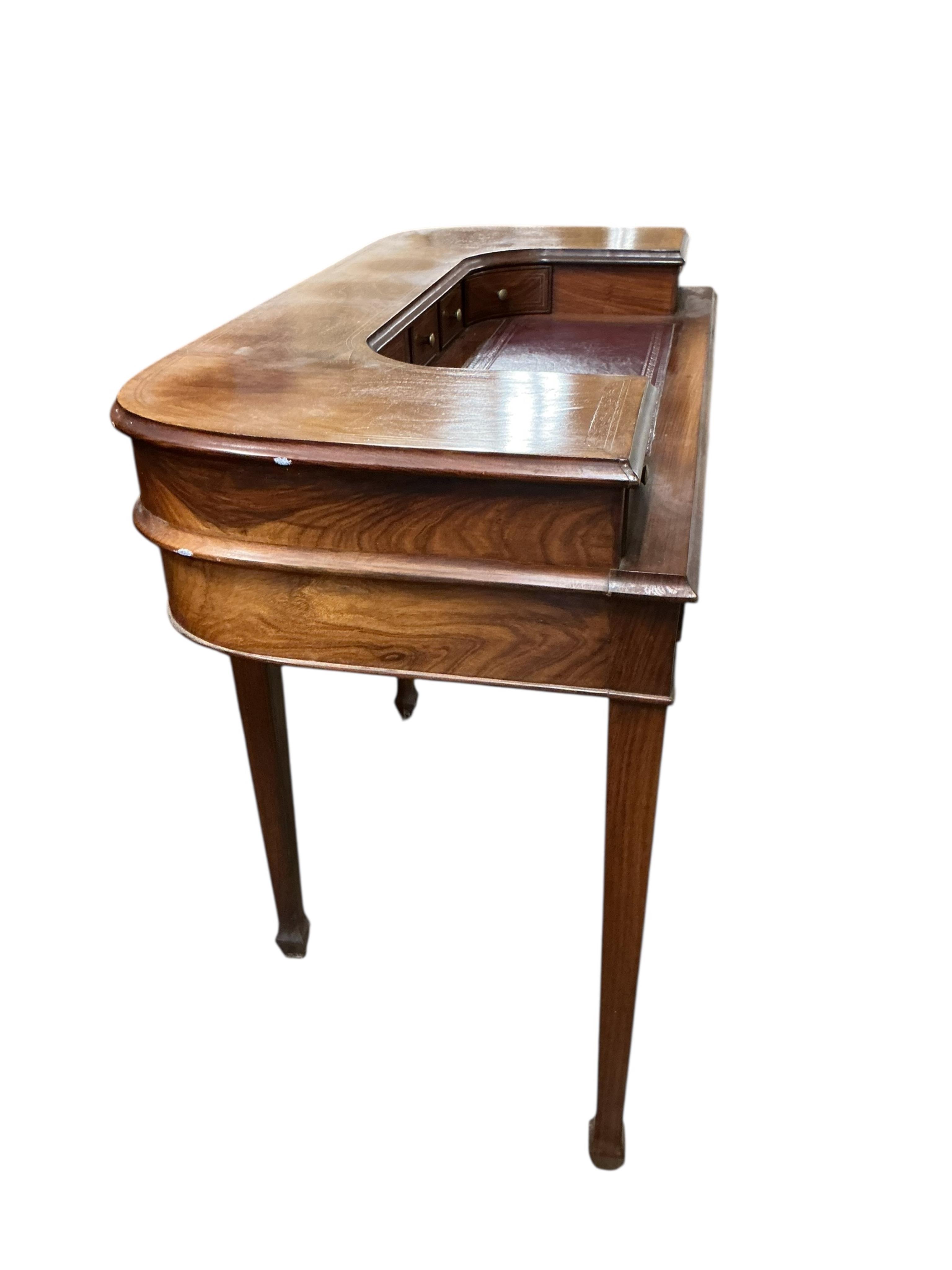 A reproduction brass inlaid mahogany Carlton House type desk, width 116cm, depth 54cm, height 87cm